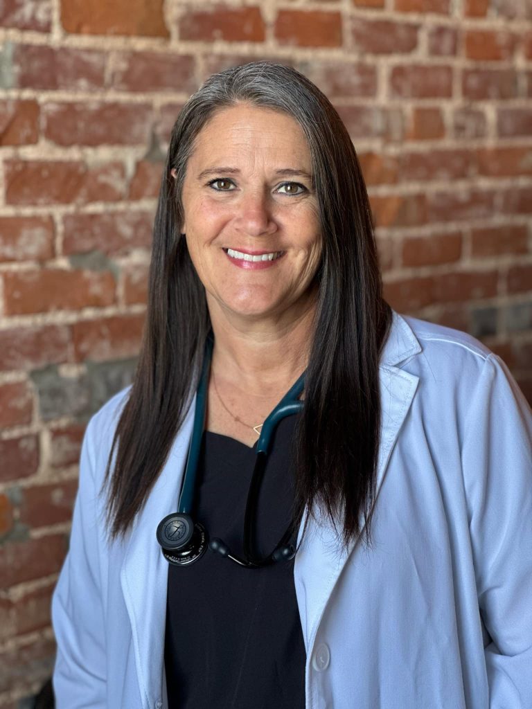 Smiling woman in medical coat